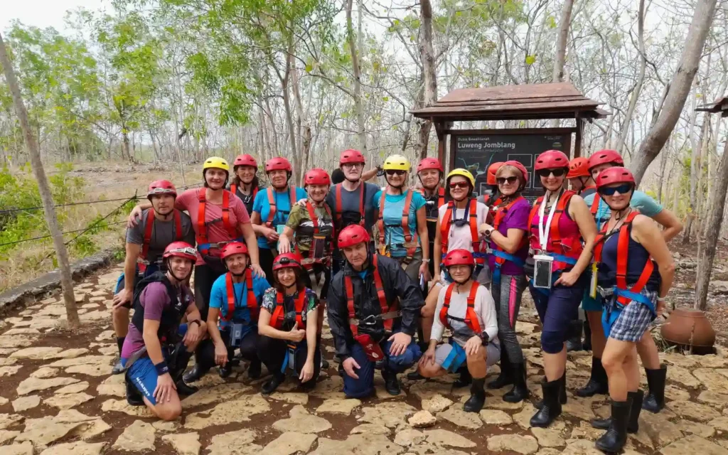 Tourists equipped with helmets and harnesses at Jomblang Cave