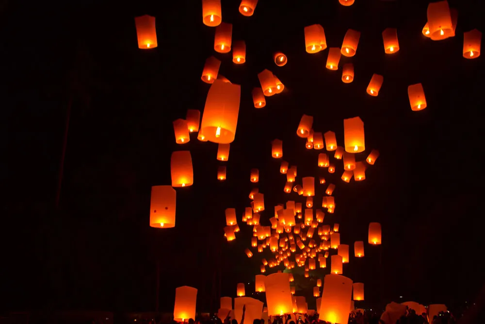 Illuminated lanterns lighting up sky